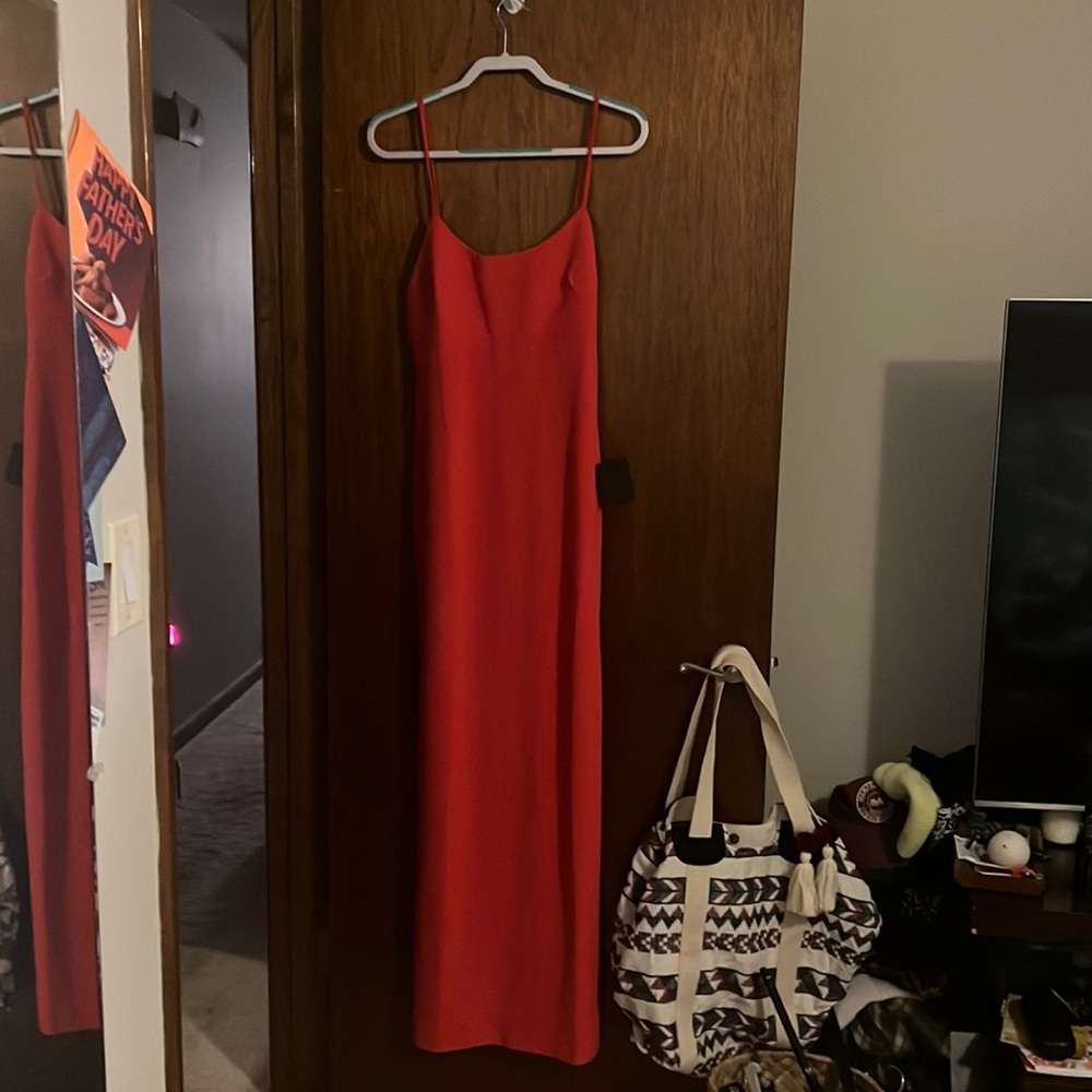Beautiful red/pink long dress with a small slit up the bottom in the back. NWT.